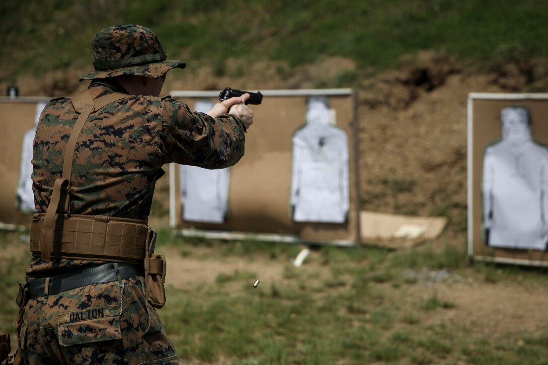 U.S. Marine Lance Cpl. Jacob A. Dalton, heavy equipment operator with Engineer Company C, 6th Engineer Support Battalion, 4th Marine Logistics Group, fires his weapon at the pistol range during exercise Red Dagger at Fort Indiantown Gap, Pa., May 15, 2018.