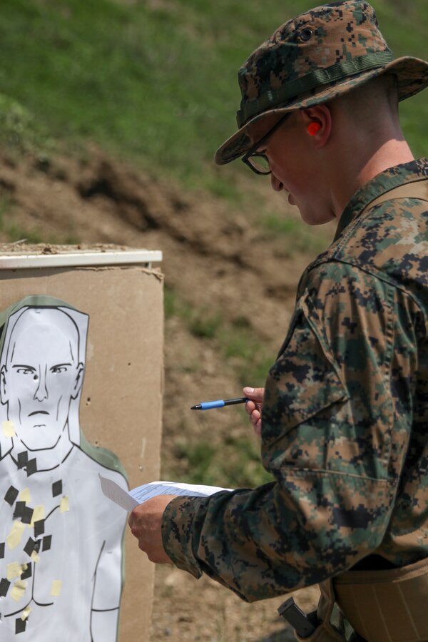 U.S. Marine Lance Cpl. Seth M. Perry, combat engineer with Engineer Company C, 6th Engineer Support Battalion, 4th Marine Logistics Group, plots his shot group from his target after shooting at the pistol range during exercise Red Dagger at Fort Indiantown Gap, Pa., May 15, 2018. Exercise Red Dagger is a bilateral training exercise that gives Marines an opportunity to exchange tactics, techniques and procedures as well as build working relationships with their British counterparts. (U.S. Marine Corps photo by Sgt. Melanie Wolf/Released)