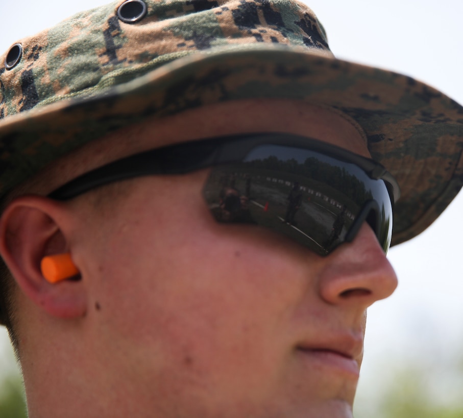 U.S. Marine Cpl. Thomas J. Smarch Jr., range coach with Engineer Support Company, 6th Engineer Support Battalion, 4th Marine Logistics Group, glances towards the firing line at the live fire pistol range during exercise Red Dagger at Fort Indiantown Gap, Pa., May 15, 2018.
