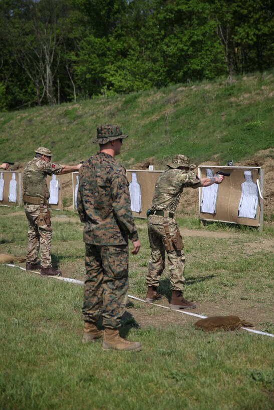 U.S. Marine Cpl. Thomas J. Smarch Jr., range coach with Engineer Support Company, 6th Engineer Support Battalion, 4th Marine Logistics Group, coaches the firing line with the British commando’s with 131 Commando Squadron Royal Engineers, British Army, at the live fire pistol range during exercise Red Dagger at Fort Indiantown Gap, Pa., May 15, 2018.