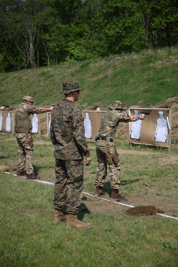 U.S. Marine Cpl. Thomas J. Smarch Jr., range coach with Engineer Support Company, 6th Engineer Support Battalion, 4th Marine Logistics Group, coaches the firing line with the British commando’s with 131 Commando Squadron Royal Engineers, British Army, at the live fire pistol range during exercise Red Dagger at Fort Indiantown Gap, Pa., May 15, 2018. Exercise Red Dagger is a bilateral training exercise that gives Marines an opportunity to exchange tactics, techniques and procedures as well as build working relationships with their British counterparts. (U.S. Marine Corps photo by Sgt. Melanie Wolf/Released)