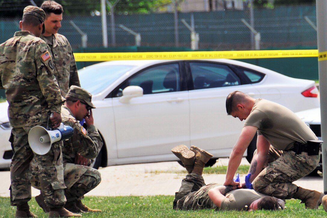 A soldier practices restraining another soldier during certification training.