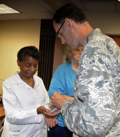 Air Force Lt. Col. Craig Abee, right, 628th Air Base Wing chaplain, blesses the hands of Naval Health Clinic Charleston nurse Barbara Mack during a "Blessing of the Hands" ceremony in celebration of National Nurses Week May 8, 2018, at NHCC located on Joint Base Charleston - Weapons Station. The "Blessing of the Hands" ceremony, a hospital tradition practiced around the world during Nurses Week, May 6-12, honors nurses who use their hands in the healing of patients. NHCC’s nurses also recited the Nightingale Pledge, a statement of ethics and principles of the nursing profession.