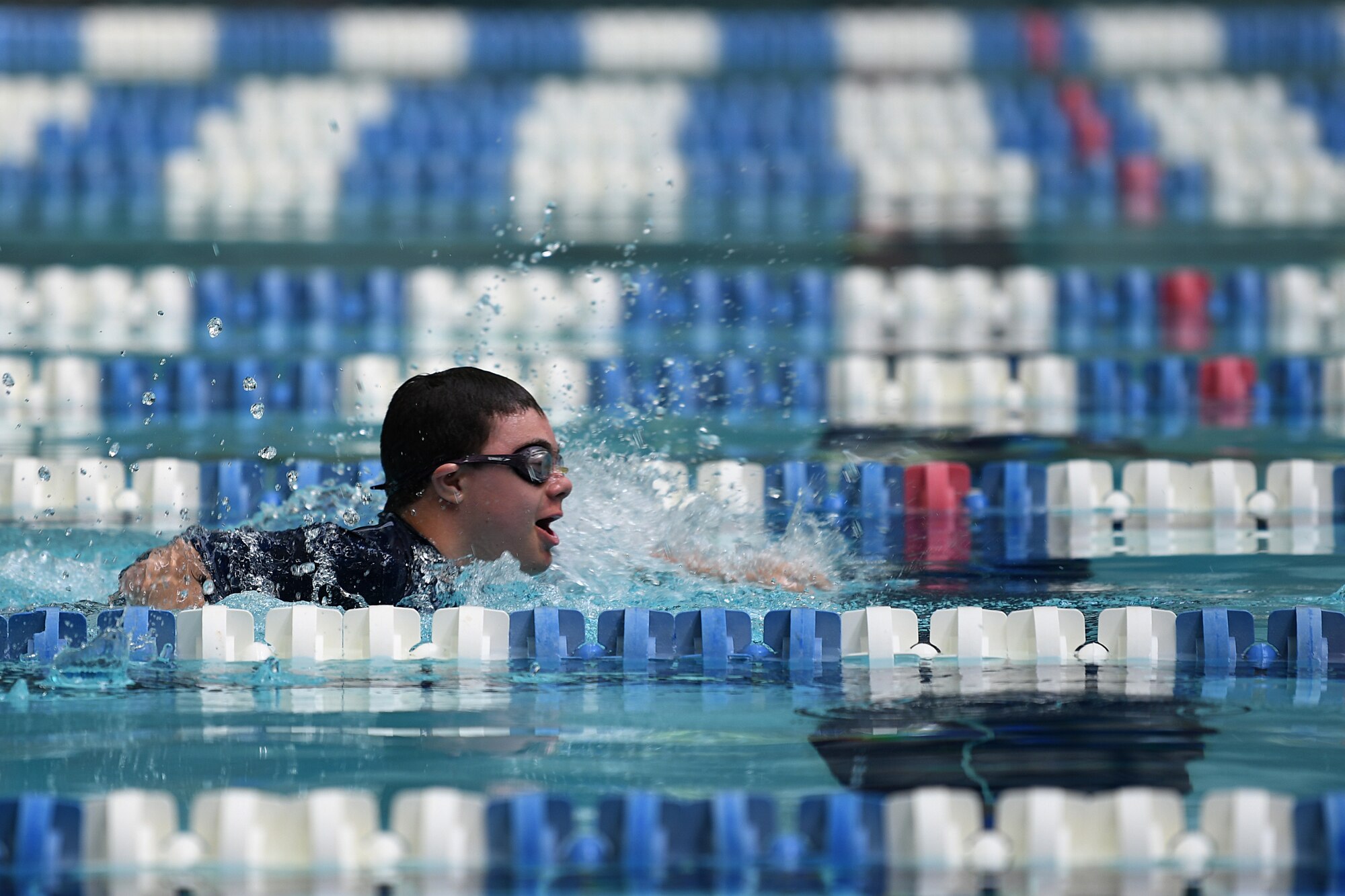 Easton Slutz, District 5 Special Olympics Mississippi athlete, swims in the 4x100 freestyle relay during SOMS at the City of Biloxi Natatorium, May 12, 2018. Slutz competed in three swimming events to include the 4x100 freestyle relay where his team won bronze. (U.S. Air Force photo by Airman 1st Class Suzie Plotnikov)