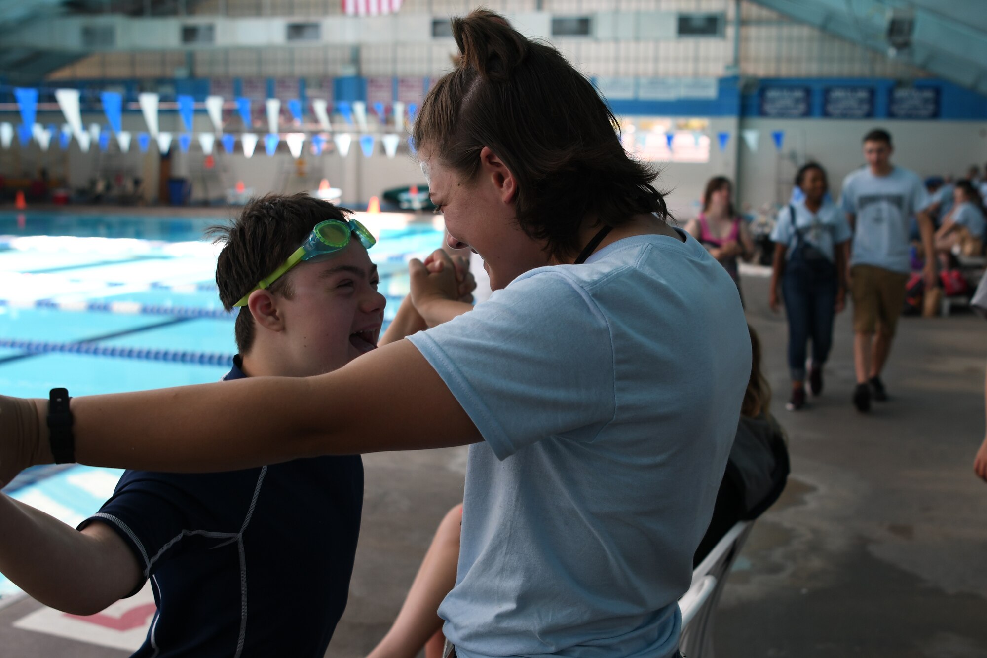 Easton Slutz, District 5 Special Olympics Mississippi athlete, celebrates with U.S. Air Force Airman Kaimryn Hursch, 336th Training Squadron student, during SOMS at the City of Biloxi Natatorium, May 12, 2018. Throughout the SOMS weekend, Slutz’s Airman Sponsors spent time and cheered him on while he competed in the 4x100 freestyle relay, 50 meter backstroke and 50 meter freestyle. (U.S. Air Force photo by Airman 1st Class Suzie Plotnikov)