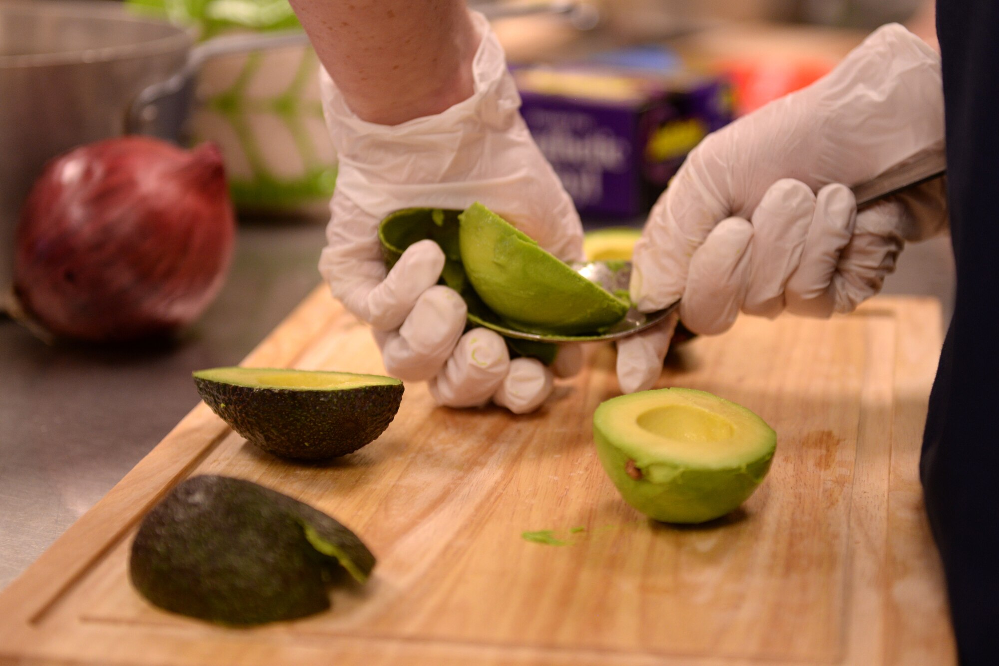 A competitor at the Taste of Luke cooking competition peels an avocado at Luke Air Force Base, Ariz., May 9, 2018. The cooking competition, like others that the 56th Force Support Squadron hosts throughout the year, required competitors to cook three different dishes, an appetizer, an entrée, and a dessert, to complete a three-course meal. (U.S. Air Force photo by Senior Airman Ridge Shan)