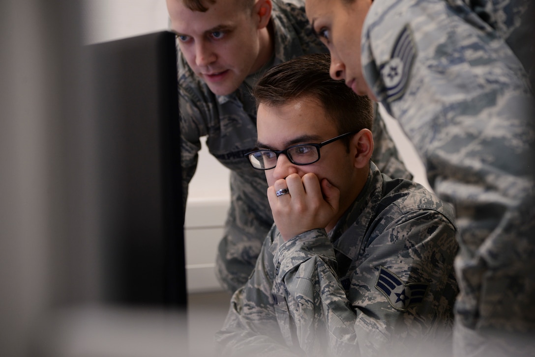 Airmen gather around computer at first U.S. Air Forces in Europe cyber-only exercise Tacet Venari at Warrior Preparation Center on Einsiedlerhof Air Station, Germany, May 10, 2018 (U.S. Air Force/Blake Browning)