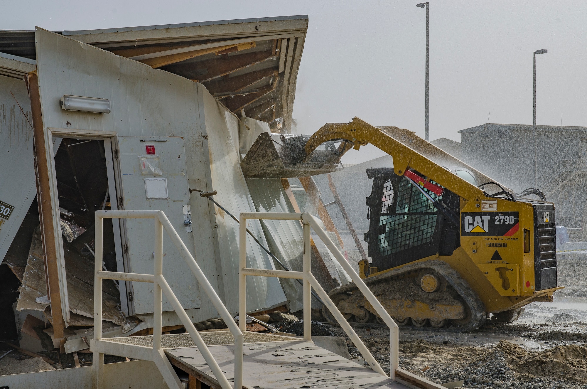 Master Sgt. Gregory Lund, heavy equipment shop chief, demolishes a building at Al Dhafra Air Base, United Arab Emirates, May 9, 2018. Heavy equipment operators construct runways and airfields in remote global locations in addition to maintaining facilities already in use.   (U.S. Air National Guard photo by Staff Sgt. Ross A. Whitley)