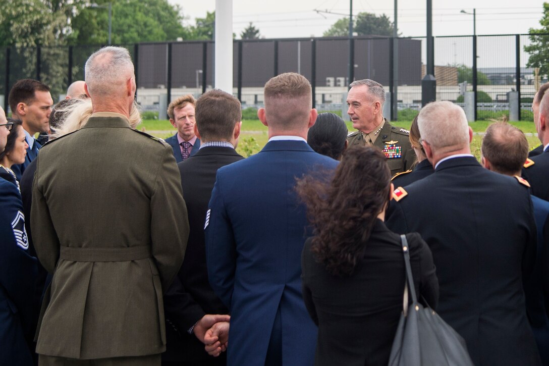 Marine Corps Gen. Joe Dunford speaks to a group of people in Brussels.