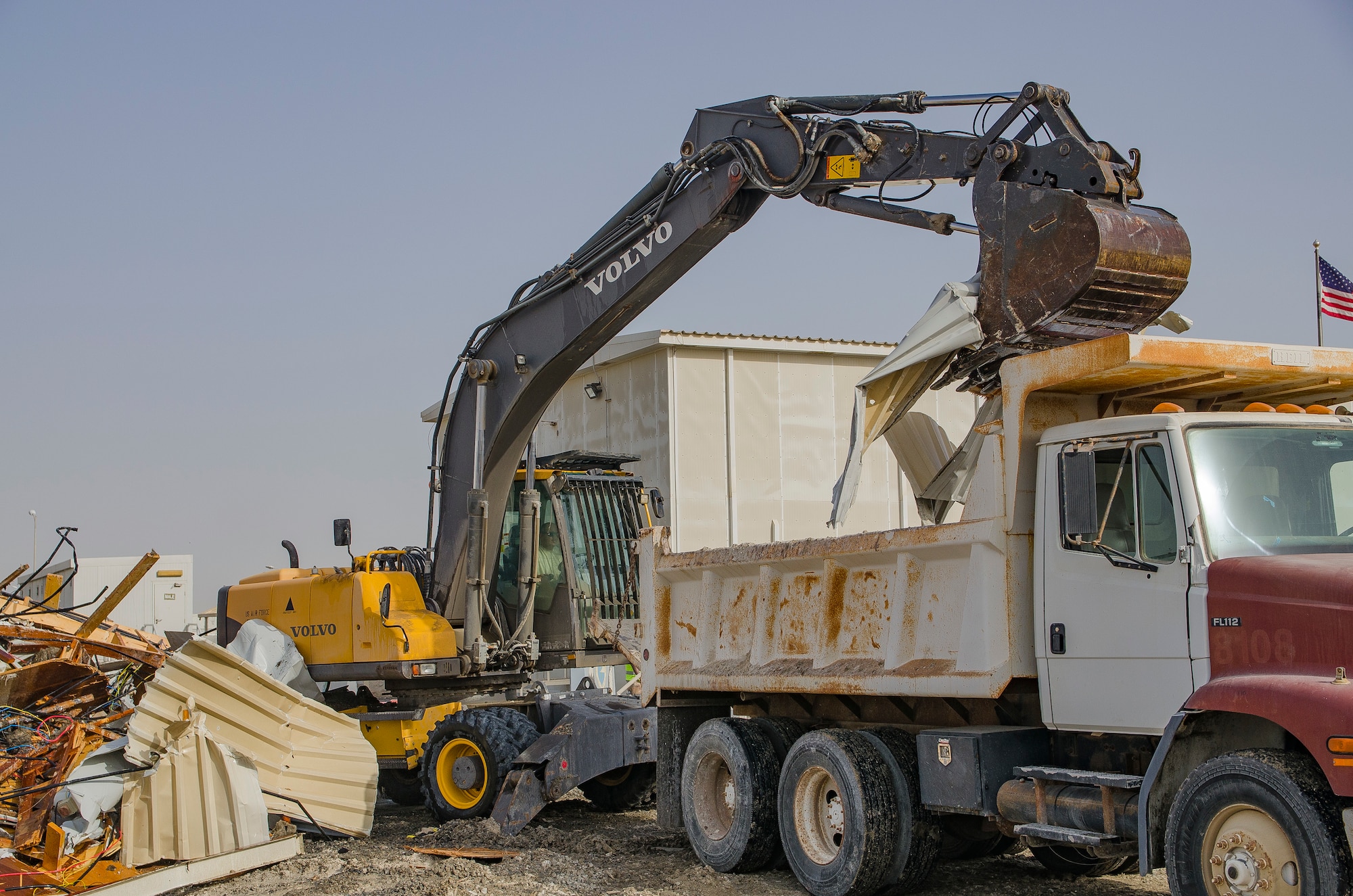 Staff Sgt. Nicholas Warkocz, pavements and heavy equipment operator, uses an excavator to remove debris from a demolished building May 9, 2018, at Al Dhafra Air Base, United Arab Emirates. Heavy equipment operators are capable of constructing, maintaining and inspecting concrete and asphalt runways, aircraft parking aprons and roads. (U.S. Air National Guard photo by Staff Sgt. Ross A. Whitley)