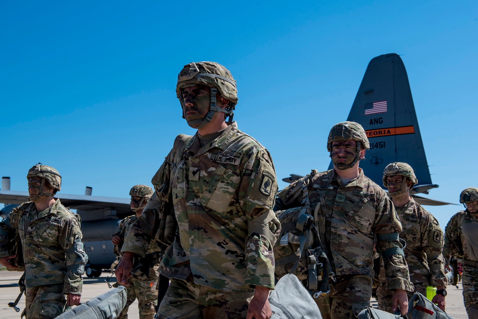U.S. Army paratroopers from the Texas Army National Guard 1st Battalion (Airborne), 143rd Infantry Regiment, stationed at Camp Swift in Bastrop, Texas, prepare to load onto a C-130H Hercules aircraft during the Minuteman Joint Forcible Entry exercise at Naval Air Station Joint Reserve Base Fort Worth, Fort Worth, Texas, April 20, 2018.