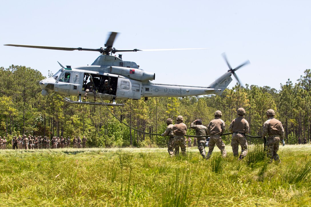 British Commandos hold a rope after fast roping from a UH-1Y helicopter during exercise Burmese Chase at Camp Lejeune, N.C., May 11, 2018. Burmese Chase is an annual U.S. led multi-lateral exercise that enables U.S. Marines to train with NATO allies and partner nations. This exercise strengthens partner nation security as well as enhances force readiness.
