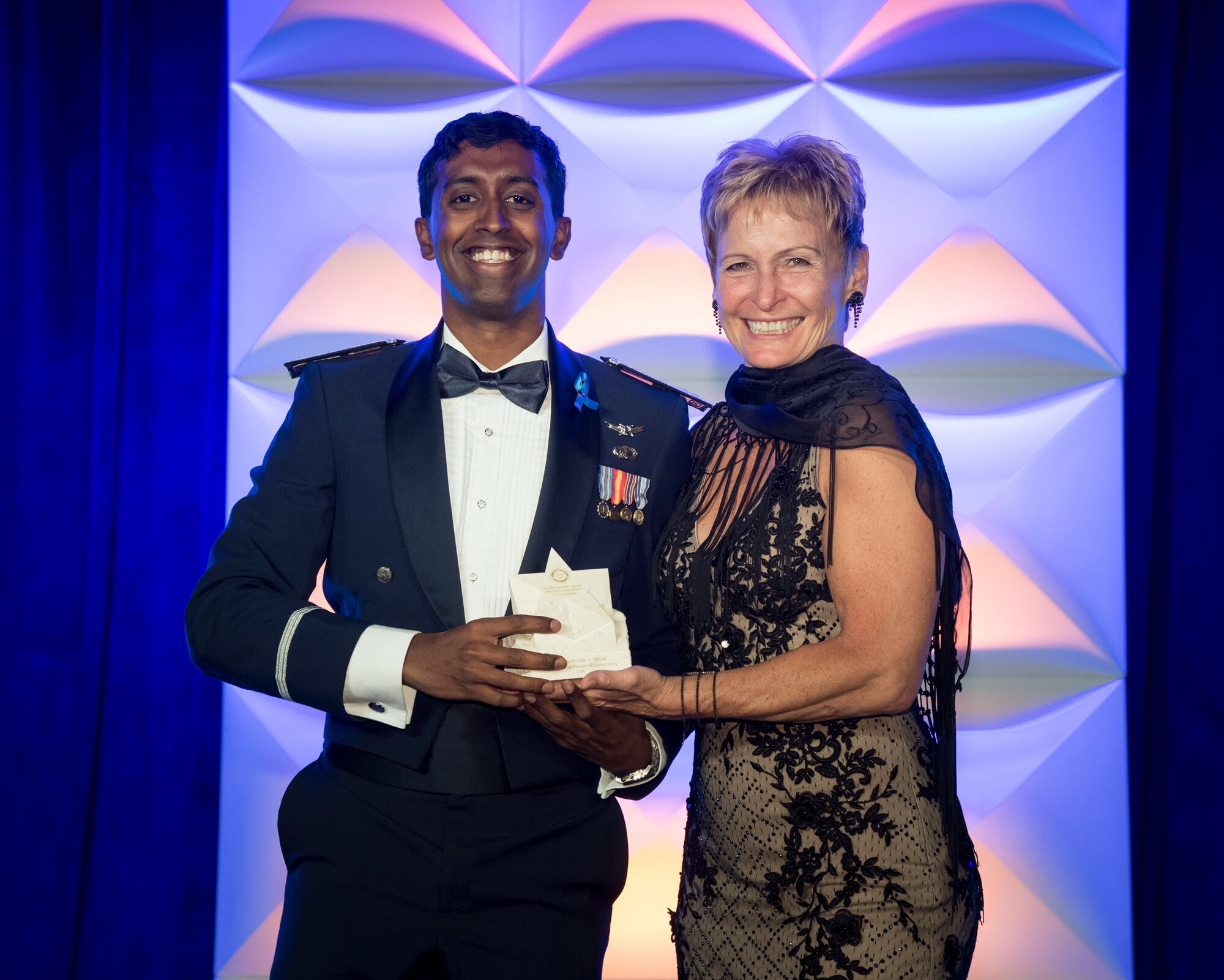 Capt. Michael Nayak receives the 2018 Rotary National Award for Space Achievement Early Career Stellar Award from Dr. Peggy Whitson, NASA astronaut and holder of the U.S. record for time spent in space. Nayak is a planetary scientist and aerospace engineer at the Air Force Research Laboratory’s Air Force Maui Optical and Supercomputing site on Maui, Hawaii.