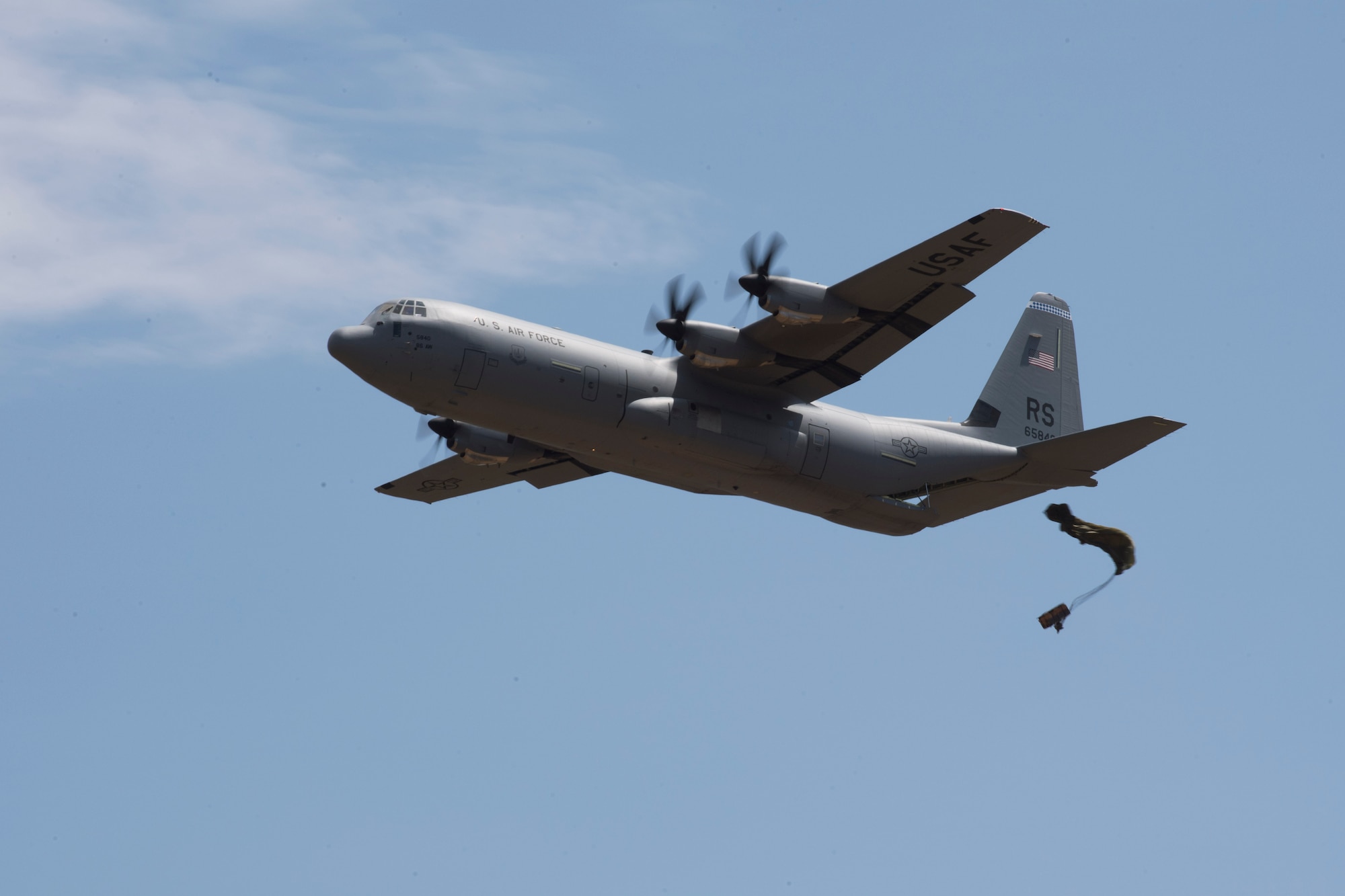A U.S. Air Force C-130J Super Hercules drops a low cost low altitude bundle during exercise Stolen Cerberus V, over Megara Drop Zone, Greece, May 15, 2018. Hellenic riggers worked with U.S. Air Force Joint Airdrop Inspectors to ensure the LCLA bundle were rigged properly. (U.S. Air Force photo by Senior Airman Devin M. Rumbaugh)