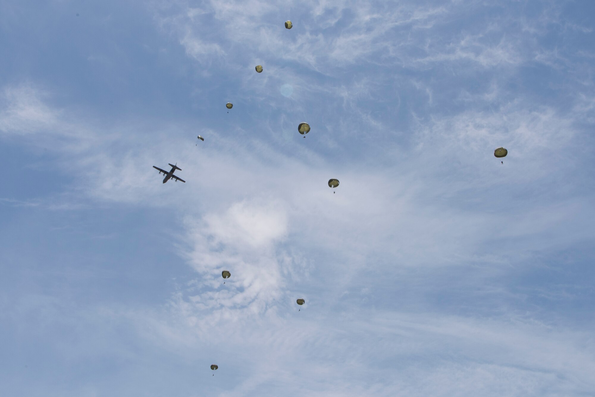 Hellenic paratroopers jump from a U.S. Air Force C-130J Super Hercules during exercise Stolen Cerberus V, over Megara Drop Zone, Greece, May 15, 2018. Hellenic riggers worked with U.S. Army jumpmasters to enhance interoperability between the respective services. (U.S. Air Force photo by Senior Airman Devin M. Rumbaugh)