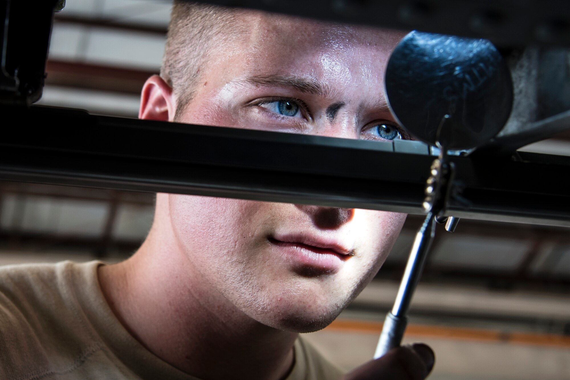 Senior Airman Kyle Mosher, 723d Aircraft Maintenance Squadron (AMXS) crew chief, inspects an HH-60G Pave Hawk railing, May 10, 2018, at Moody Air Force Base, Ga. Airmen from the 723d AMXS along with machinists from the Corpus Christi Army Depot conducted a full-structural tear down and restoration on an HH-60G Pave Hawk. Once the aircraft was torn down, Airmen and the machinists performed repairs on all of its components prior to resembling it. (U.S. Air Force photo by Airman 1st Class Eugene Oliver)