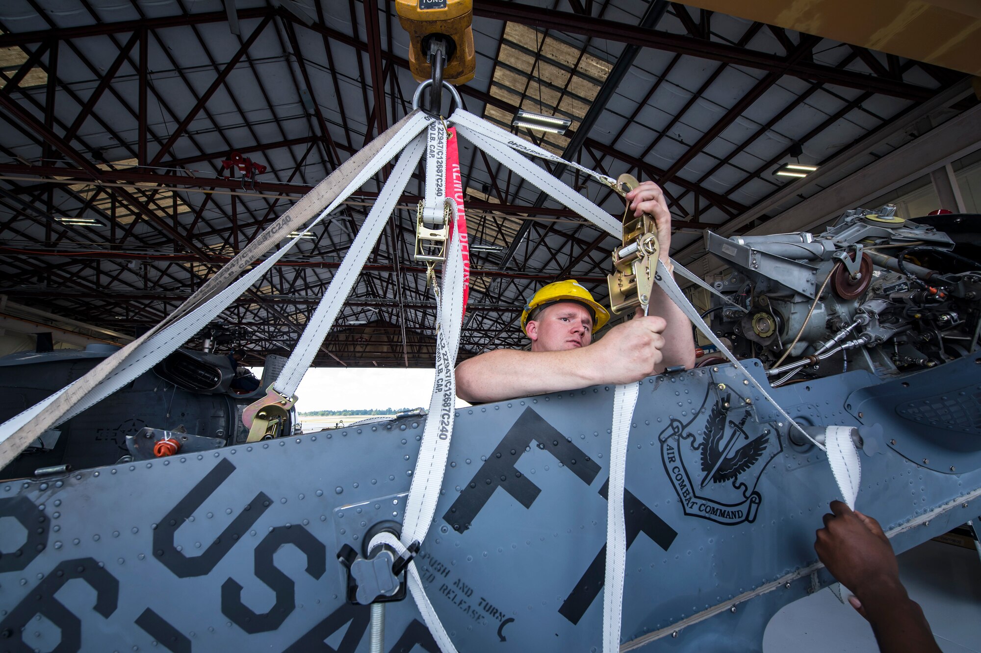 Staff Sgt. David Melton, 723d Aircraft Maintenance Squadron (AMXS) crew chief, attaches a pulley mechanism to an HH-60G Pave Hawk tail pylon, May 10, 2018, at Moody Air Force Base, Ga. Airmen from the 723d AMXS along with machinists from the Corpus Christi Army Depot conducted a full-structural tear down and restoration on an HH-60G Pave Hawk. Once the aircraft was torn down, Airmen and the machinists performed repairs on all of its components prior to resembling it. (U.S. Air Force photo by Airman 1st Class Eugene Oliver)