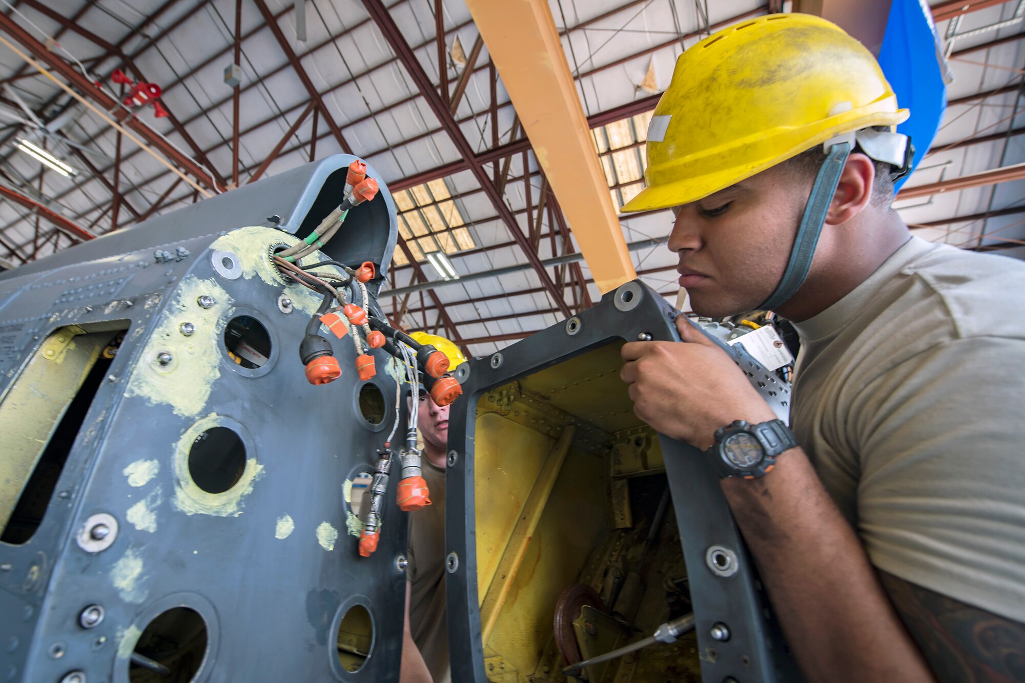 Airman 1st Class Andre Butler, 723d Aircraft Maintenance Squadron (AMXS) crew chief, attaches a tail pylon to an HH-60G Pave Hawk, May 10, 2018, at Moody Air Force Base, Ga. Airmen from the 723d AMXS along with machinists from the Corpus Christi Army Depot conducted a full-structural tear down and restoration on an HH-60G Pave Hawk. Once the aircraft was torn down, Airmen and the machinists performed repairs on all of its components prior to resembling it. (U.S. Air Force photo by Airman 1st Class Eugene Oliver)