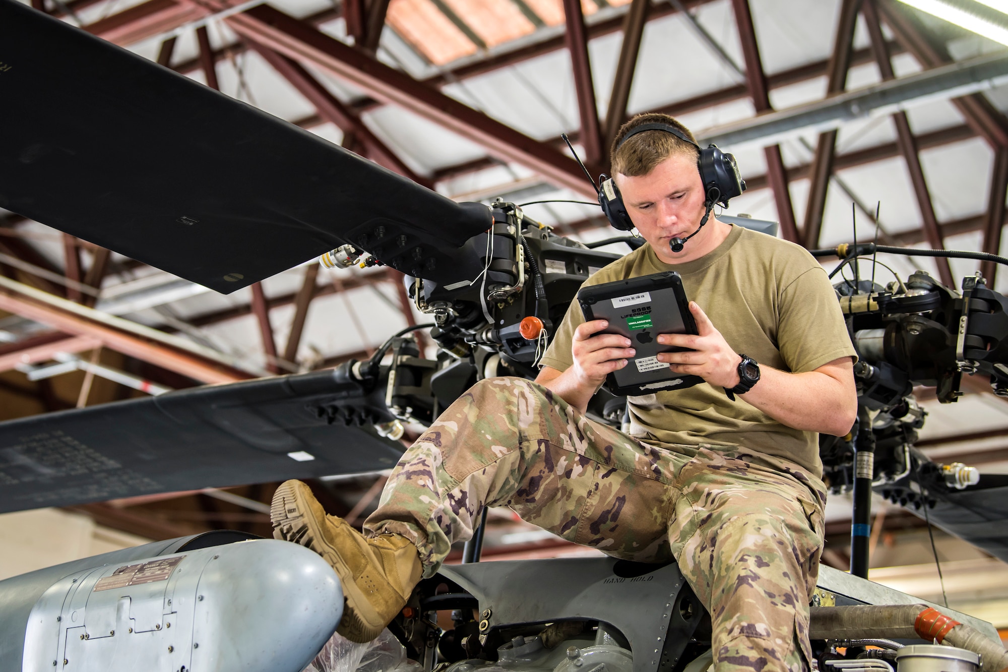 Staff Sgt. David Melton, 723d Aircraft Maintenance Squadron (AMXS) crew chief, reads a technical order, May 15, 2018, at Moody Air Force Base, Ga. Airmen from the 723d AMXS along with machinists from the Corpus Christi Army Depot conducted a full-structural tear down and restoration on an HH-60G Pave Hawk. Once the aircraft was torn down, Airmen and the machinists performed repairs on all of its components prior to resembling it. (U.S. Air Force photo by Airman 1st Class Eugene Oliver)