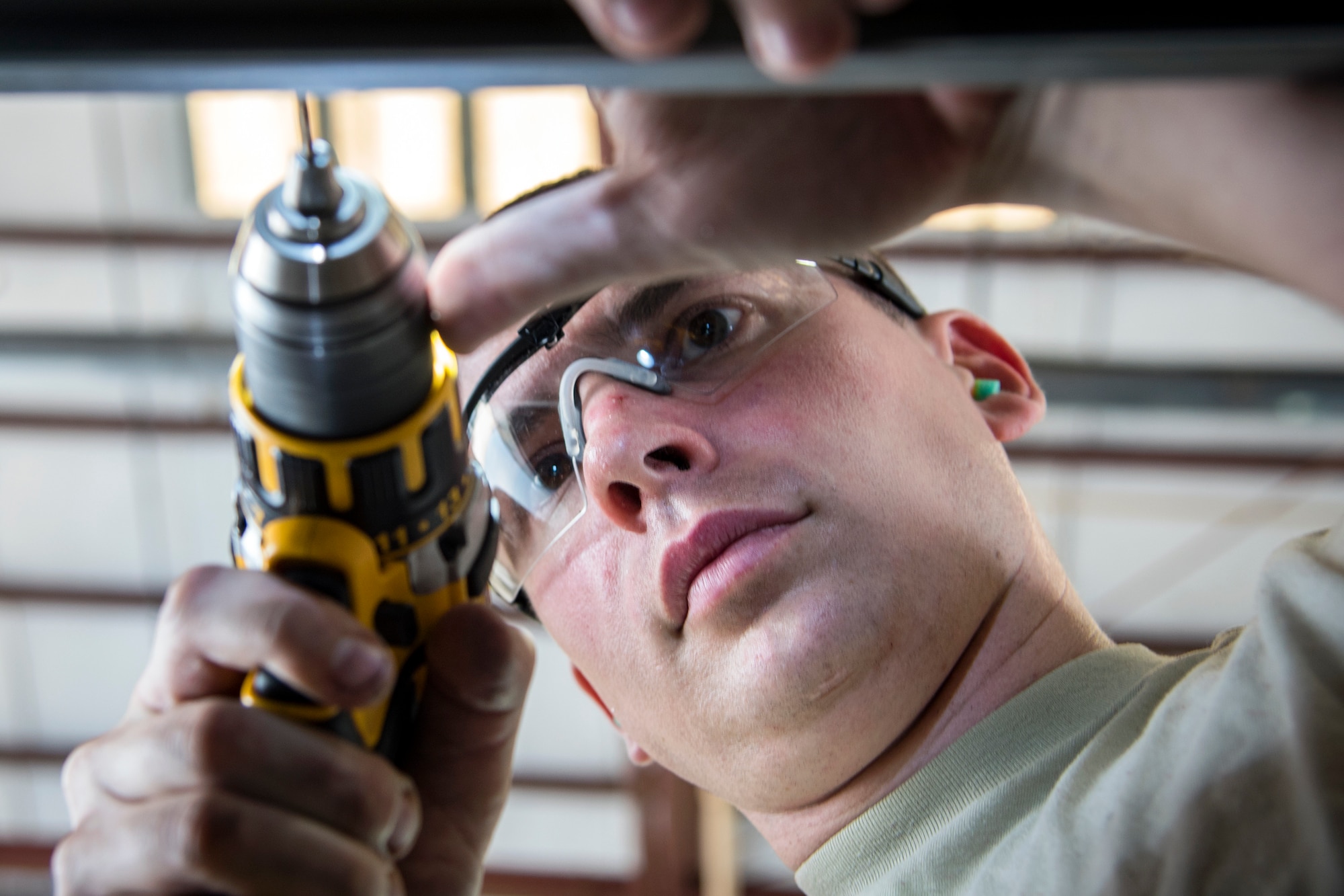 Senior Airman Reed Robitzsch, 723d Aircraft Maintenance Squadron (AMXS) aircraft structural maintenance journeyman, attaches a railing to an HH-60G Pave Hawk, May 10, 2018, at Moody Air Force Base, Ga. Airmen from the 723d AMXS along with machinists from the Corpus Christi Army Depot conducted a full-structural tear down and restoration on an HH-60G Pave Hawk. Once the aircraft was torn down, Airmen and the machinists performed repairs on all of its components prior to resembling it.  (U.S. Air Force photo by Airman 1st Class Eugene Oliver)