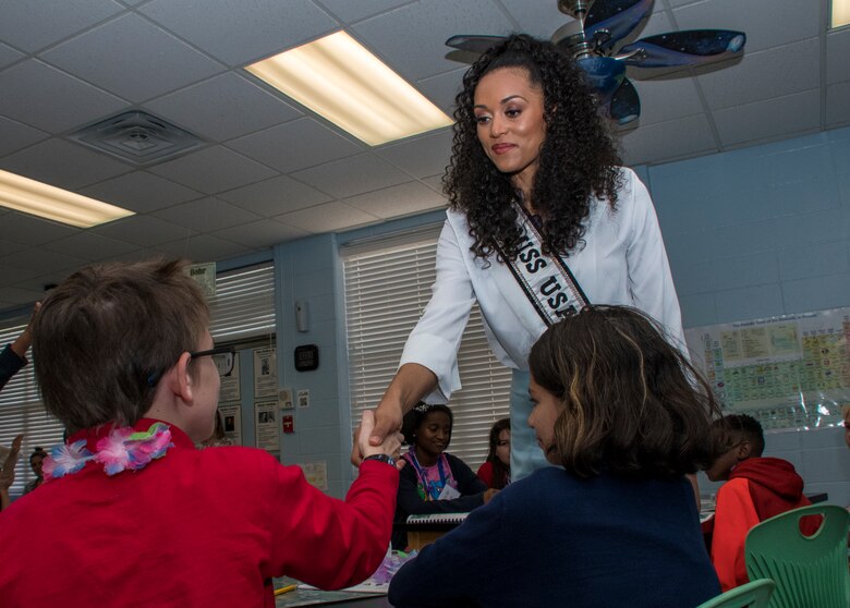 Kara McCullough, Miss USA 2017, shakes a student's hand during her visit to STARBASE Louisiana on Barksdale Air Force Base, Louisiana, May 15, 2018.