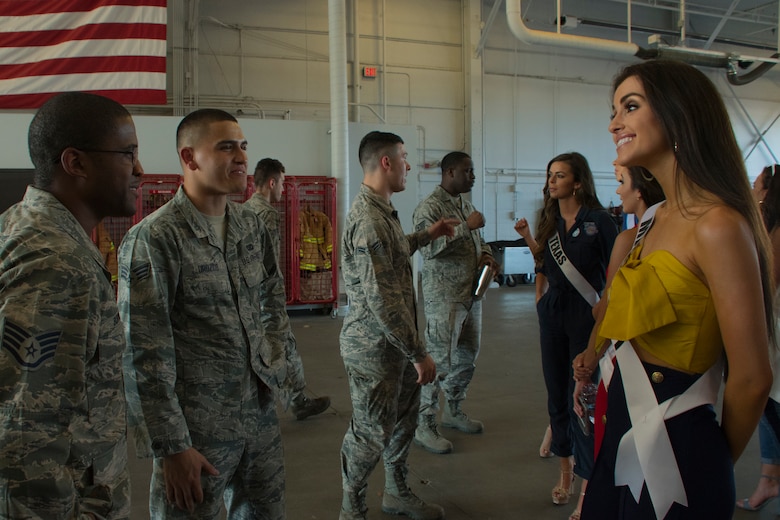 Laine Mansour, Miss Mississippi USA 2018, talks with firefighters at Barksdale Air Force Base, Louisiana, during her visit to Barksdale with other contestants in the 2018 Miss USA pageant May 15, 2018.