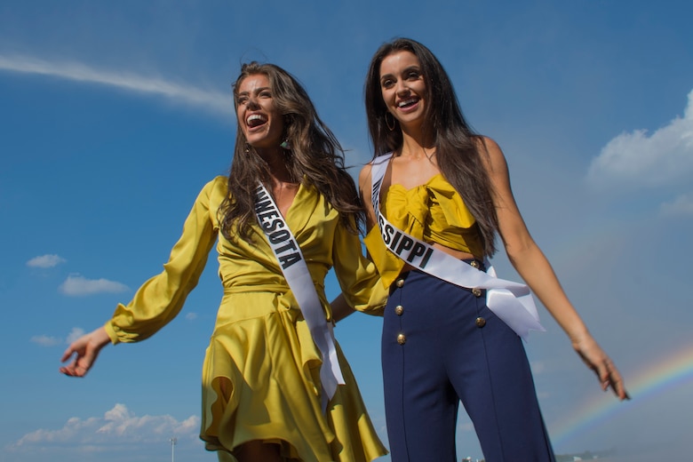Kalie Wright, Miss Minnesota USA 2018, and Laine Mansour, Miss Mississippi USA 2018, stand in front of water spray from a fire truck during their tour of Barksdale Air Force Base, Louisiana, May 15, 2018.