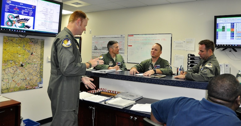 – Lt. Col. Eric Waddell (left) provides the ‘step brief’ to 39th FTS members during the Cobra in the Clouds exercise. (Left Center- Lt. Col Damian Olivieri, Center Lt. Col. Ben Price, Right Lt. Col. Kyle Goldstein). (U.S. Air Force photo by Janis El Shabazz)