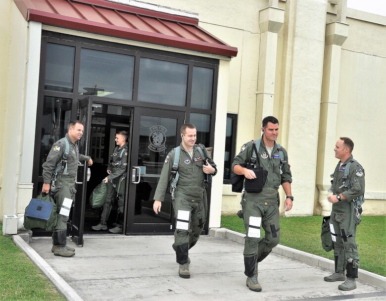 39th FTS Cobras stepping to the aircraft with their flight gear and mission materials. 
Left to right Lt. Col. Kyle Goldstein, 2nd Lt. Jacob Summerhays, Capt. Joshua Smith, Maj. Jeff Nelson, Lt. Col. Ben Price. (U.S. Air Force photo by Janis El Shabazz)