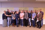 Twenty-three Lean Six Sigma students from Louisiana, Florida and Georgia stand with their instructors and higher-ups after taking four week-long classes at Jackson Barracks in New Orleans. The Louisiana National Guard was the first state to implement LSS in its planning to reduce waste while generating savings and cost avoidance.
