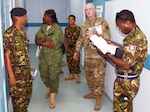 Master Sgt. Joseph Cole (center), from the U.S. Army’s Louisiana National Guard's Construction Facility Management Office, and service members from the Belize Defence Force, participate in a site survey and facility assessment exercise of a military hospital in Belize City May 9.