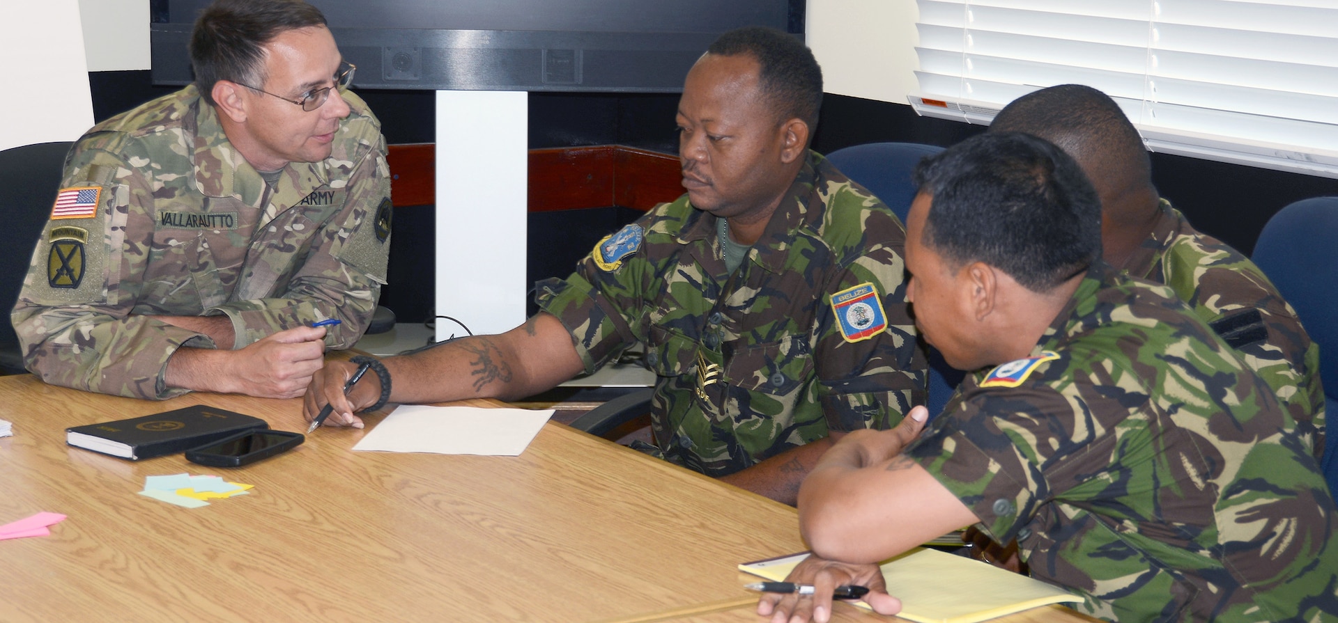 (From left) Capt. James Hoover, U.S. Army Louisiana National Guard; Cpl. Obedio Keh and Capt. Darius Ramos, Belize Defense Force, participate in a table top exercise during an Energy and Water Conservation Policy Subject Matter Expert Exchange in Belize City May 8.