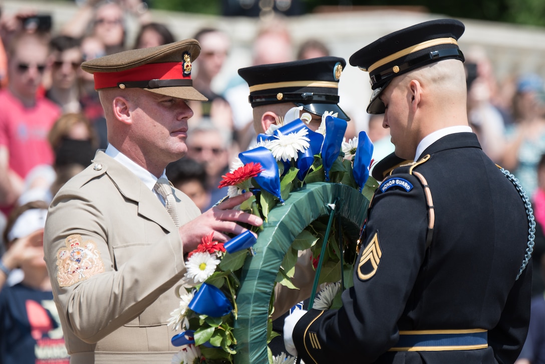 U.S. Army Command Sgt. Maj. John W. Troxell, Senior Enlisted Advisor to the Chairman of the Joint Chiefs of Staff, and British Army Warrant Officer Class One Glenn Haughton, Army Sgt. Maj., visit Arlington National Cemetery.