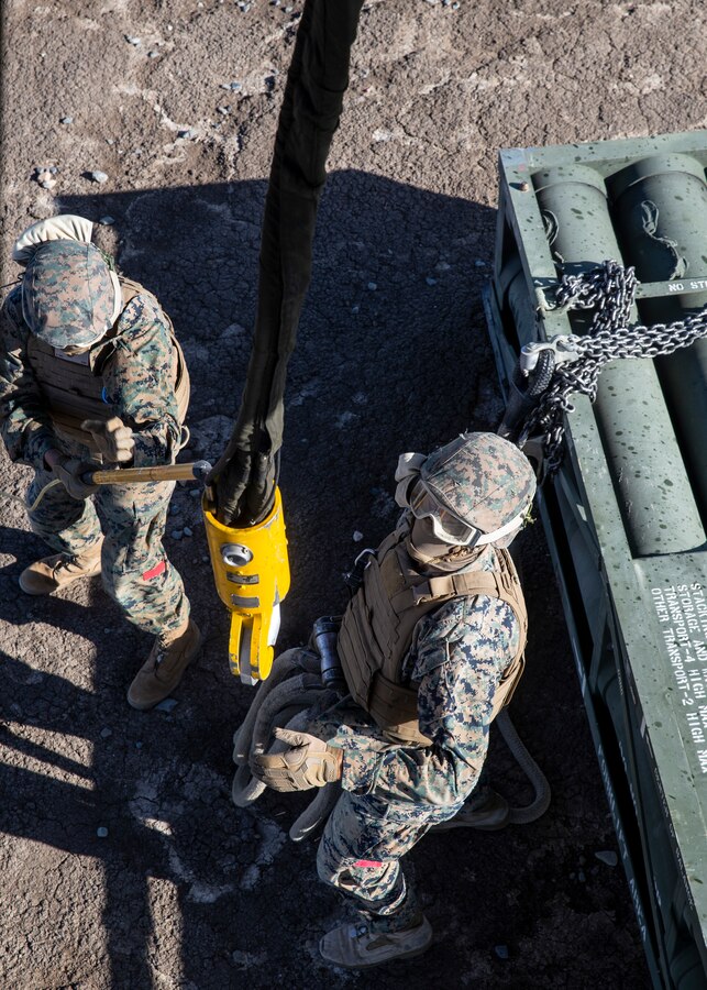 Lance Cpl. Jacobee Jackson, left, and Lance Cpl. Adrian Morales, right, both landing support specialists with 1st Transport Support Battalion, Combat Logistics Regiment 1, 1st Marine Logistics Group hook High-Mobility Artillery Rocket System (HIMARS) pods to a CH-53E Super Stallion with Marine Heavy Helicopter Squadron (HMH) 462, Marine Aircraft Group 16, 3rd Marine Aircraft Wing on Marine Corps Base Camp Pendleton, Calif., May 15. HMH-462 conducted training that implemented cargo pick-up and drop off to enhance their units’ skills and proficiency with cargo movement and operations. (U.S. Marine Corps photo by Lance Cpl. Clare J. McIntire/Released)