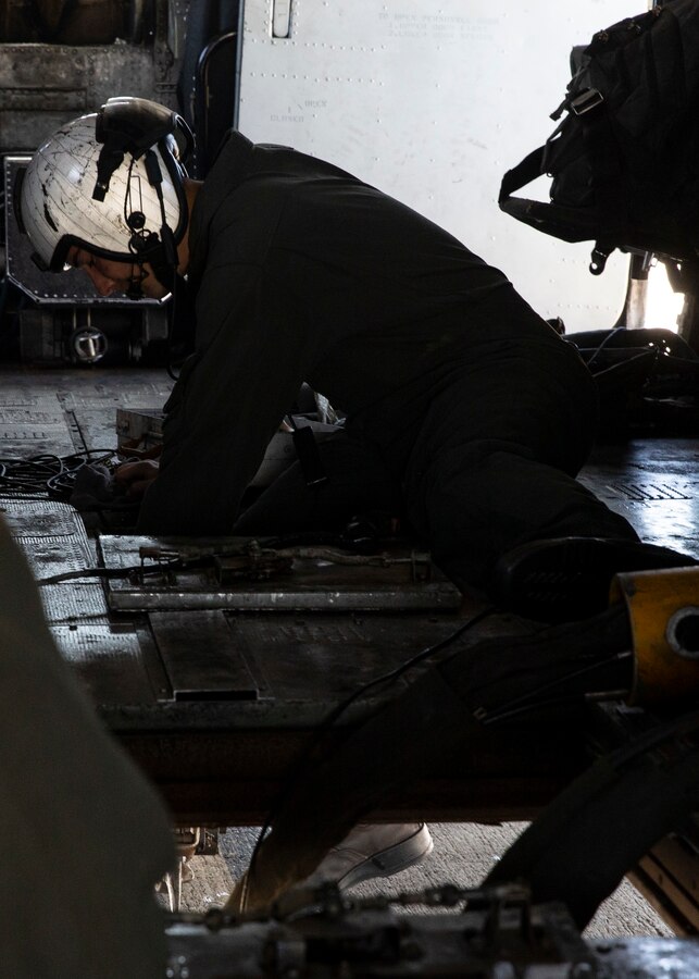 Sgt. Edward Smock, a CH-53E Super Stallion crew chief with Marine Heavy Helicopter Squadron (HMH) 462, Marine Aircraft Group 16, 3rd Marine Aircraft Wing, attaches dual point hooks on a CH-53E Super Stallion during air delivery operations at Marine Corps Base Camp Pendleton, Calif., May 15. HMH-462 conducted training implementing cargo pick-up and drop off to enhance the units’ skills and proficiency with cargo movement and operations. (U.S. Marine Corps photo by Lance Cpl. Clare J. McIntire/Released)