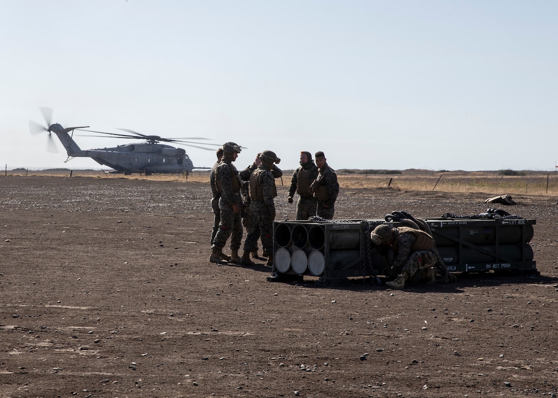 Marines with 1st Transport Support Battalion, Combat Logistics Regiment 1, 1st Marine Logistics Group, prepare High-Mobility Artillery Rocket System (HIMARS) pods for air delivery operations with Marine Heavy Helicopter Squadron (HMH) 462, Marine Aircraft Group 16, 3rd Marine Aircraft Wing, at Marine Corps Base Camp Pendleton, Calif., May 15. HMH-462 conducted training implementing cargo pick-up and drop off to enhance the units’ skills and proficiency with cargo movement and operations. (U.S. Marine Corps photo by Lance Cpl. Clare J. McIntire/Released)