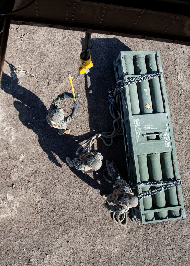 Marines with 1st Transport Support Battalion, Combat Logistics Regiment 1, 1st Marine Logistics Group hook High-Mobility Artillery Rocket System (HIMARS) pods to a CH-53E Super Stallion with Marine Heavy Helicopter Squadron (HMH) 462, Marine Aircraft Group 16, 3rd Marine Aircraft Wing on Marine Corps Base Camp Pendleton, Calif., May 15. HMH-462 conducted training that implemented cargo pick-up and drop off to enhance their units’ skills and proficiency with cargo movement and operations. (U.S. Marine Corps photo by Lance Cpl. Clare J. McIntire/Released)
