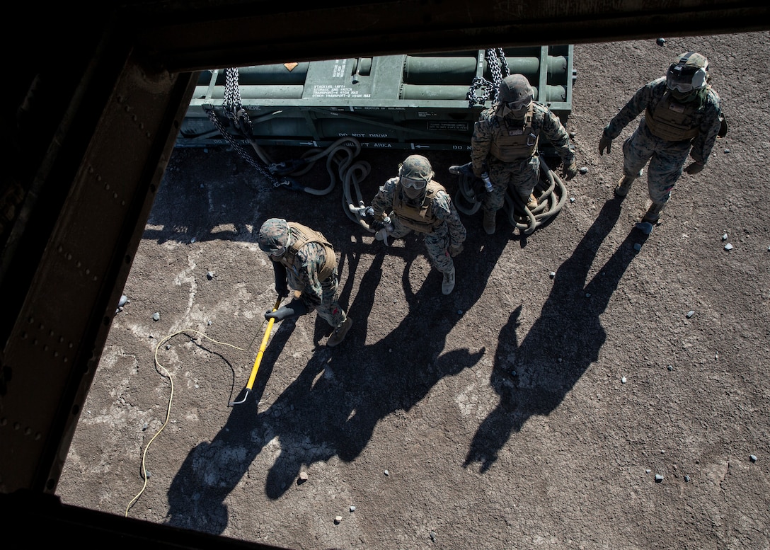 Marines with 1st Transport Support Battalion, Combat Logistics Regiment 1, 1st Marine Logistics Group prepare to High-Mobility Artillery Rocket System (HIMARS) pods to a CH-53E Super Stallion with Marine Heavy Helicopter Squadron (HMH) 462, Marine Aircraft Group 16, 3rd Marine Aircraft Wing on Marine Corps Base Camp Pendleton, Calif., May 15. HMH-462 conducted training that implemented cargo pick-up and drop off to enhance their units’ skills and proficiency with cargo movement and operations. (U.S. Marine Corps photo by Lance Cpl. Clare J. McIntire/Released)