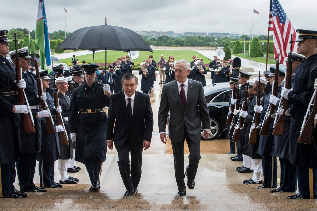 Defense Secretary James N. Mattis and a foreign leader walk up the steps of the Pentagon..