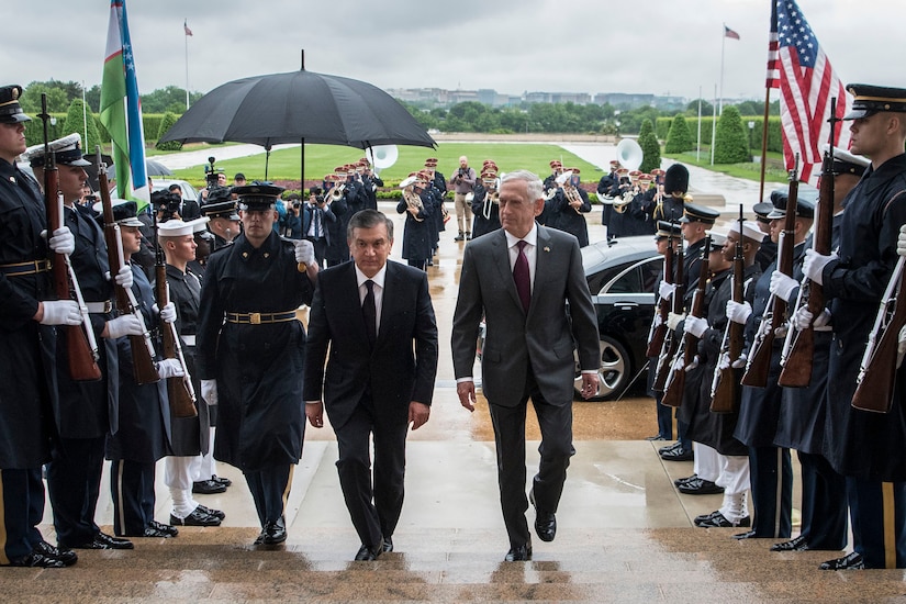 Defense Secretary James N. Mattis and a foreign leader walk up the steps of the Pentagon..