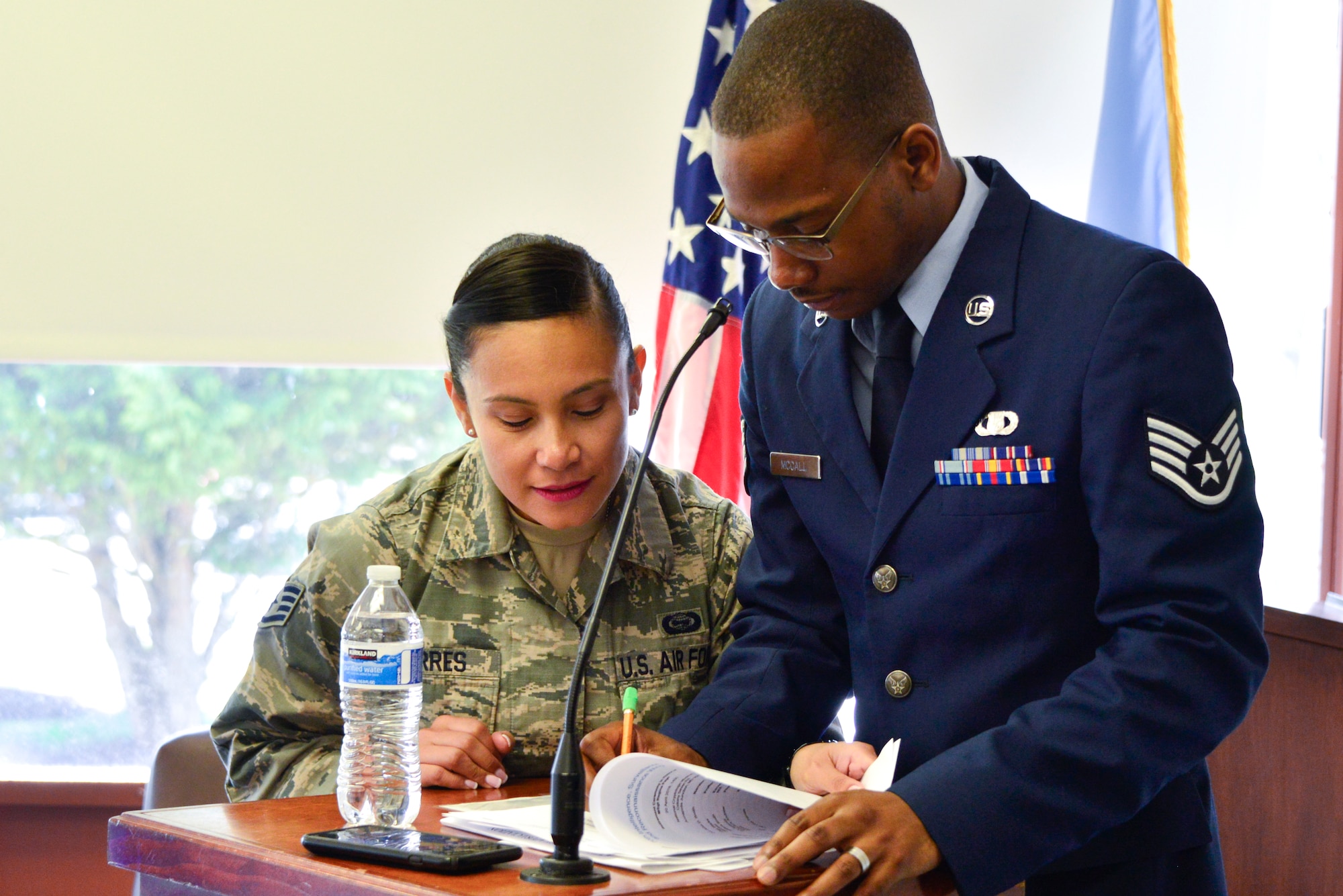 Staff Sgt. Lina Torres, 70th Intelligence, Surveillance and Reconnaissance Wing Protocol non-commissioned officer in charge, reviews a script with Staff Sgt. Marcus McCall, 70th ISRW chaplain’s office NCOIC for resource management, before a retirement ceremony April 20, 2018, Fort George G. Meade, Maryland. McCall is part of the 2017 Air Force Best Small Chapel team. (U.S. Air Force photo by Staff Sgt. Alexandre Montes)