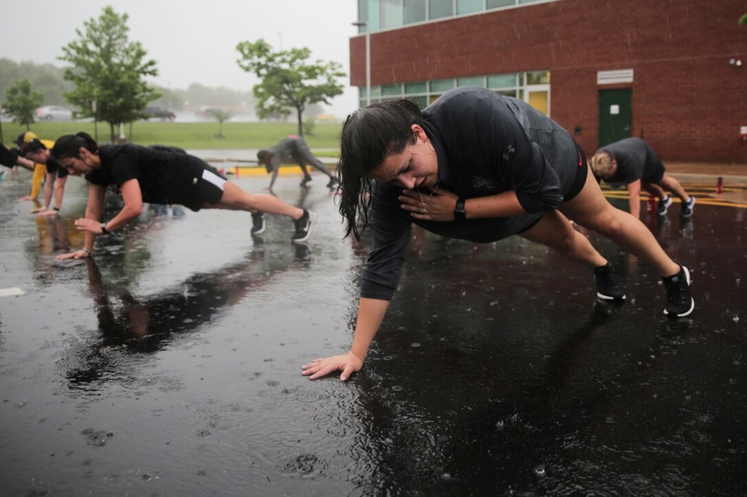 Coach Faith Avalos exercises during a wake up and workout session at Marine Corps Recruiting Command’s 2018 Coaches Workshop in Dumfries, Virginia, May 17. The Coaches Workshop educates approximately 50 collegiate coaches from across the nation about essential Marine Corps leadership skills and programs that they can share with their student athletes based on first-hand experiences. Avalos is a member of the American Volleyball Coaches Association (AVCA), an organization that educates volleyball coaches, recognizes elite players and coaches, and promotes volleyball competitions and networking opportunities for volleyball members. The Marine Corps partners with the AVCA to inspire coaches via Marine Corps leadership styles and characteristics, creating brand advocates among the organization’s key influencers. Avalos is the head volleyball coach for Mid-America Christian University in Oklahoma City, Oklahoma. (Marine Corps photo by Pfc. Phuchung Nguyen)