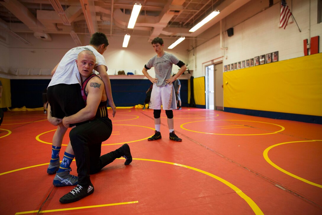 Sgt. Raymund Bunker, U.S. Marines the All-Marine Wrestling Team, demonstrates different techniques during an after school workout at the Los Alamitos High School with students from the surrounding area of Los Alamitos, Ca. May 15, 2018. The All-Marine Wrestling team held demonstrations and technique clinics in the southern California area to exhibit the Marine Corps values of Honor, Courage and Commitment to young students and aspiring wrestlers. (U.S. Marine Corps photo by Sgt. Taylor Schrick)
