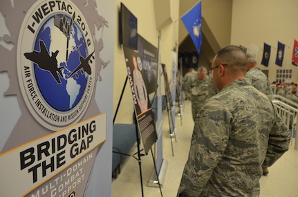 2018 Installation and Mission Support Weapons and Tactics Conference attendees read about one of the four mission area working group chairmen who led a team to think innovatively in tackling one of the Air Force’s toughest agile combat support challenges during the San Antonio event out-brief. The May 16 out-brief presented proposed solutions to about 1,000 senior Air Force leaders and members of the installation and mission support community. (U.S. Air Force photo by Armando Perez)