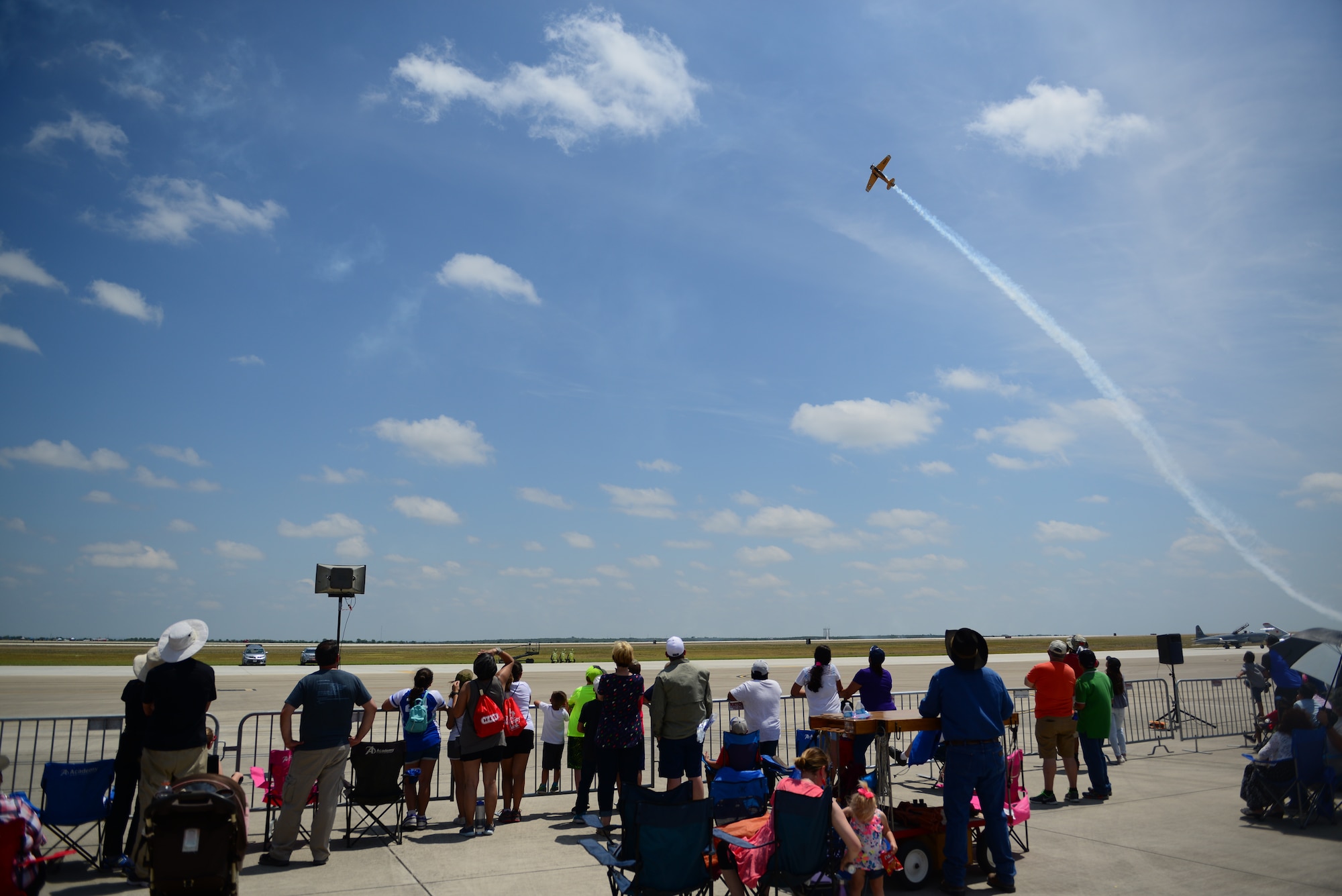 Attendees of Laughlin Air Force Base’s open house and airshow, “Fiesta of Flight,” watch as a performer navigates the Texas skies, May 12, 2018. With more than 20,000 people in attendance, aircraft from various generations displayed their aerial capabilities. (U.S. Air Force photo by Senior Airman Benjamin N. Valmoja)
