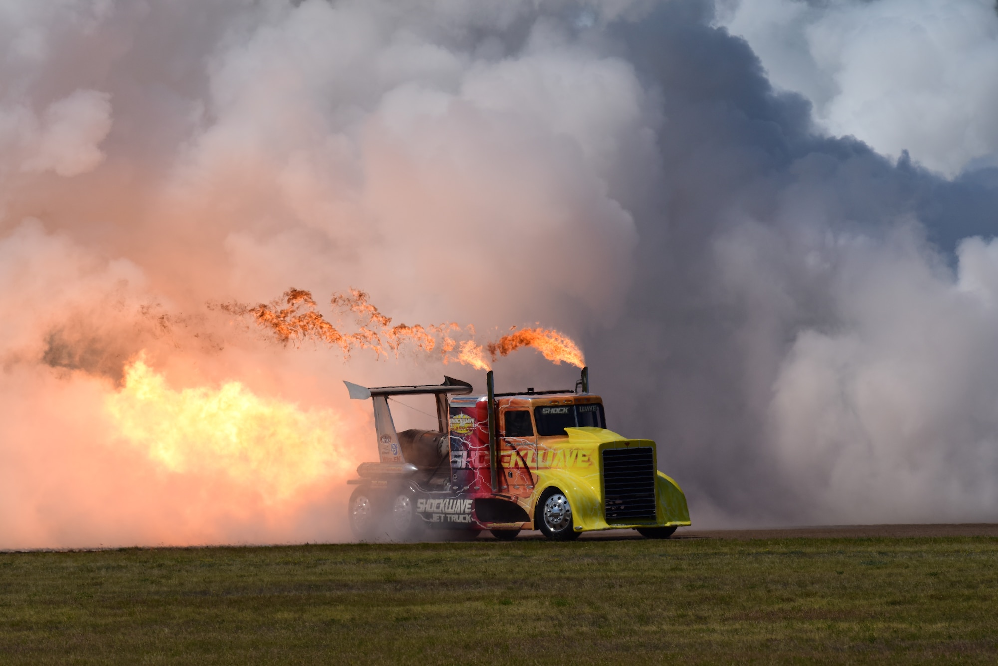 The “Shockwave” jet truck emerges from a cloud of smoke just before a 360-mile-an-hour pass down the runway at Laughlin’s Open House and Airshow, “Fiesta of Flight,” on Laughlin Air Force Base, Texas, May 12, 2018. Shockwave, along with 15 other performers put on a spectacle for more than 22,000 attendees at the airshow. (U.S. Air Force photo by Tech. Sgt. Mike Meares)