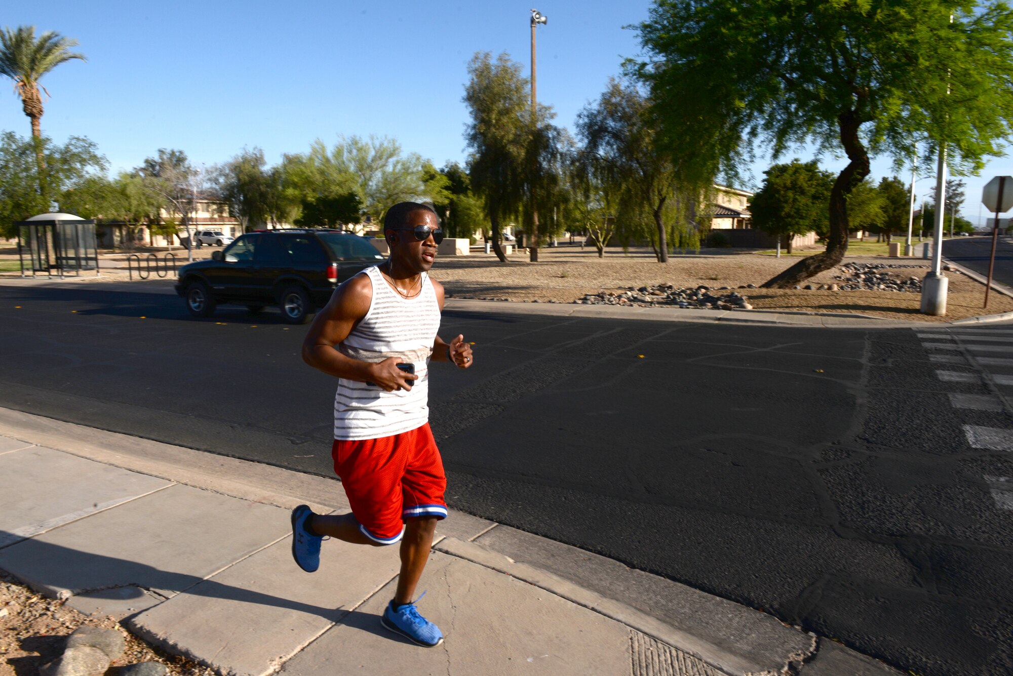 An individual runs during the Air Force Assistance Fund 5-kilometer Fun Run May 11, 2018, at Luke Air Force Base, Ariz. The run began at the base track, looped through the residential area of the base, and returned to the track. Created in 1957, the annual six-week campaign raises money for charitable affiliates that provide support to Airmen and their families in times of financial need. (U.S. Air Force photo by Senior Airman Ridge Shan)