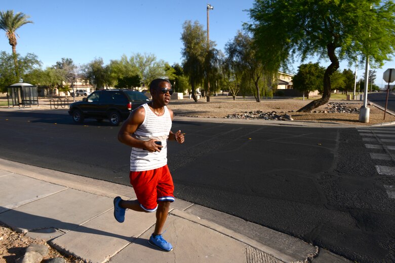 An individual runs during the Air Force Assistance Fund 5-kilometer Fun Run May 11, 2018, at Luke Air Force Base, Ariz. The run began at the base track, looped through the residential area of the base, and returned to the track. Created in 1957, the annual six-week campaign raises money for charitable affiliates that provide support to Airmen and their families in times of financial need. (U.S. Air Force photo by Senior Airman Ridge Shan)
