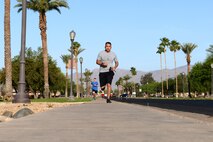 Luke Airmen run down the road during the Air Force Assistance Fund 5-kilometer Fun Run May 11, 2018, at Luke Air Force Base, Ariz. The run helped to raise awareness for the AFAF campaign that offers financial assistance to Active Duty and retired Airmen and their families in the form of small loans, education loans and grants, and living conditions. (U.S. Air Force photo by Senior Airman Ridge Shan)