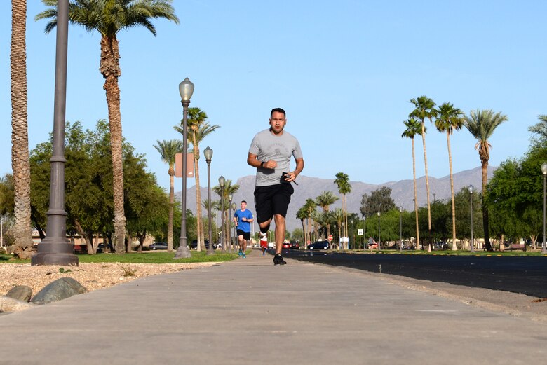 Luke Airmen run down the road during the Air Force Assistance Fund 5-kilometer Fun Run May 11, 2018, at Luke Air Force Base, Ariz. The run helped to raise awareness for the AFAF campaign that offers financial assistance to Active Duty and retired Airmen and their families in the form of small loans, education loans and grants, and living conditions. (U.S. Air Force photo by Senior Airman Ridge Shan)